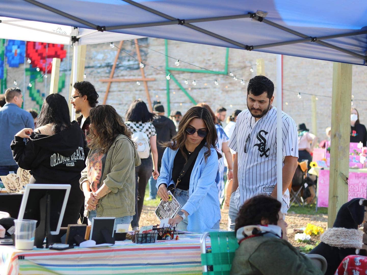People enjoying ArtWauk festival at Waukegan arts event in Illinois.