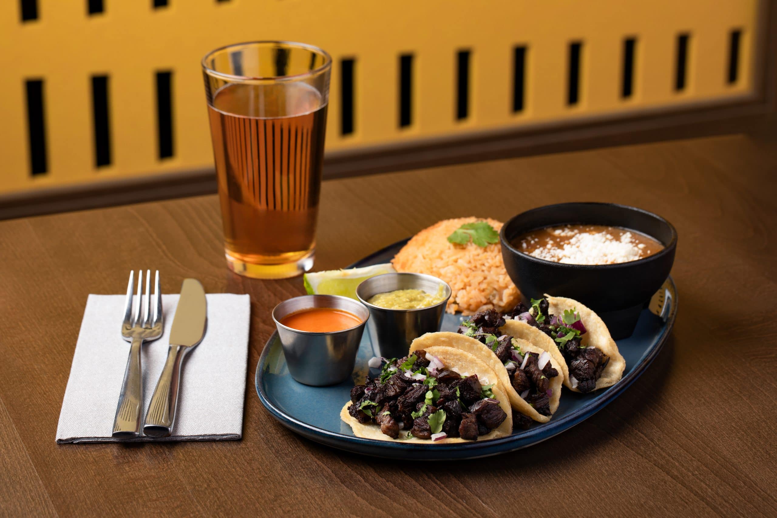 Mexican tacos with sides and a drink at a Waukegan restaurant.