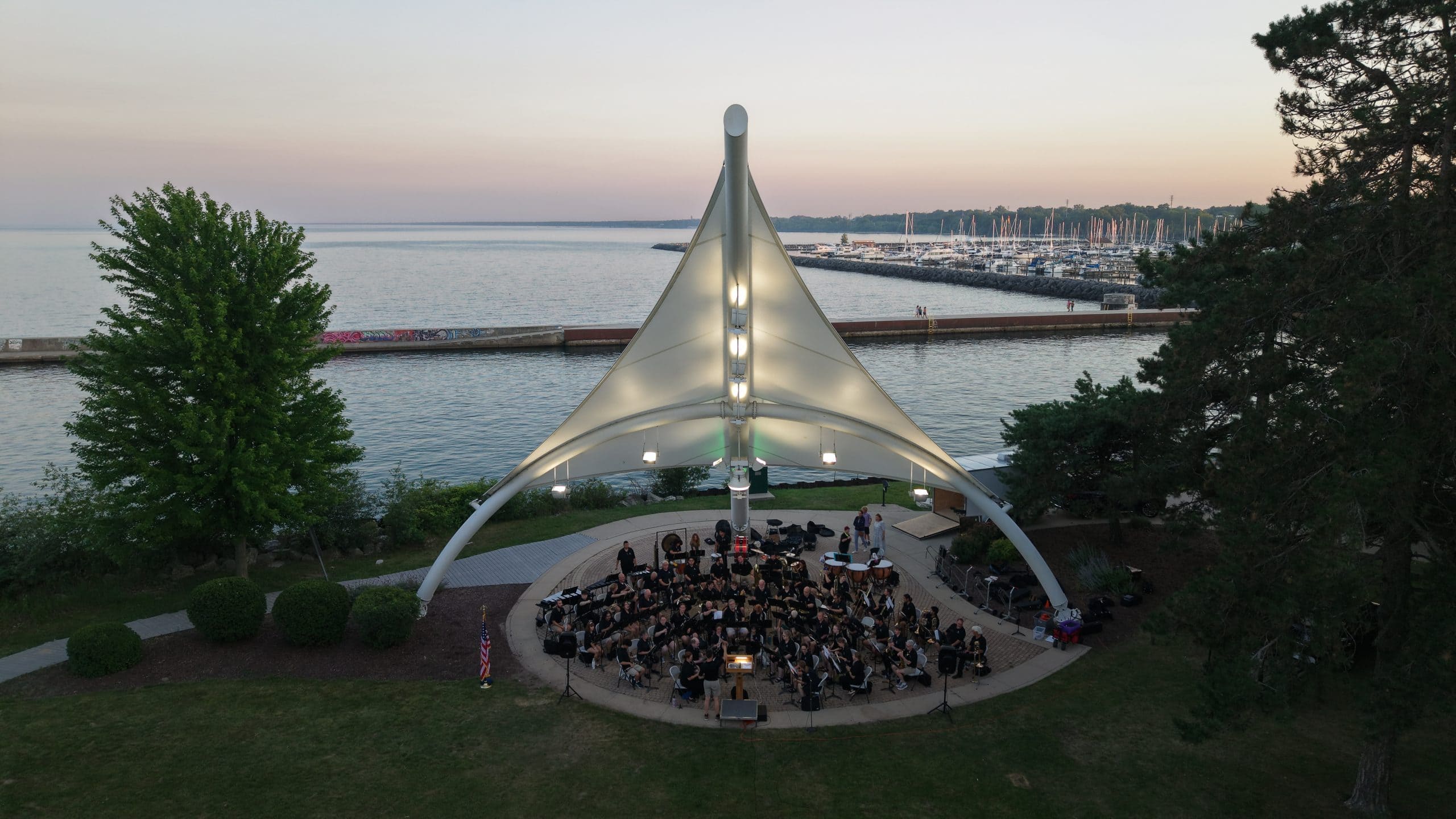 Outdoor concert stage at Waukegan Lake Michigan shoreline at sunset.