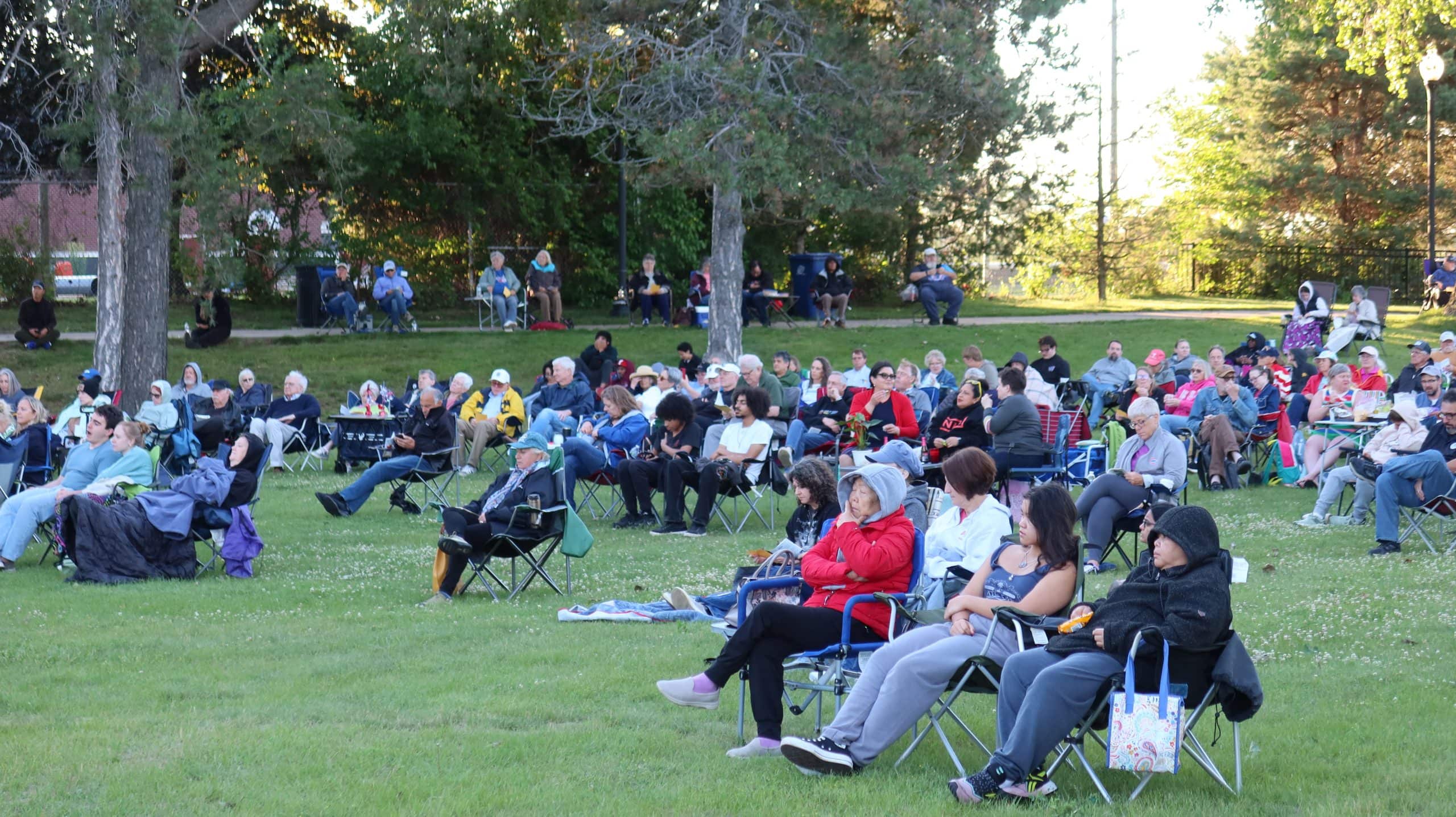 Crowd enjoying outdoor concert at Waukegan park near Lake Michigan.