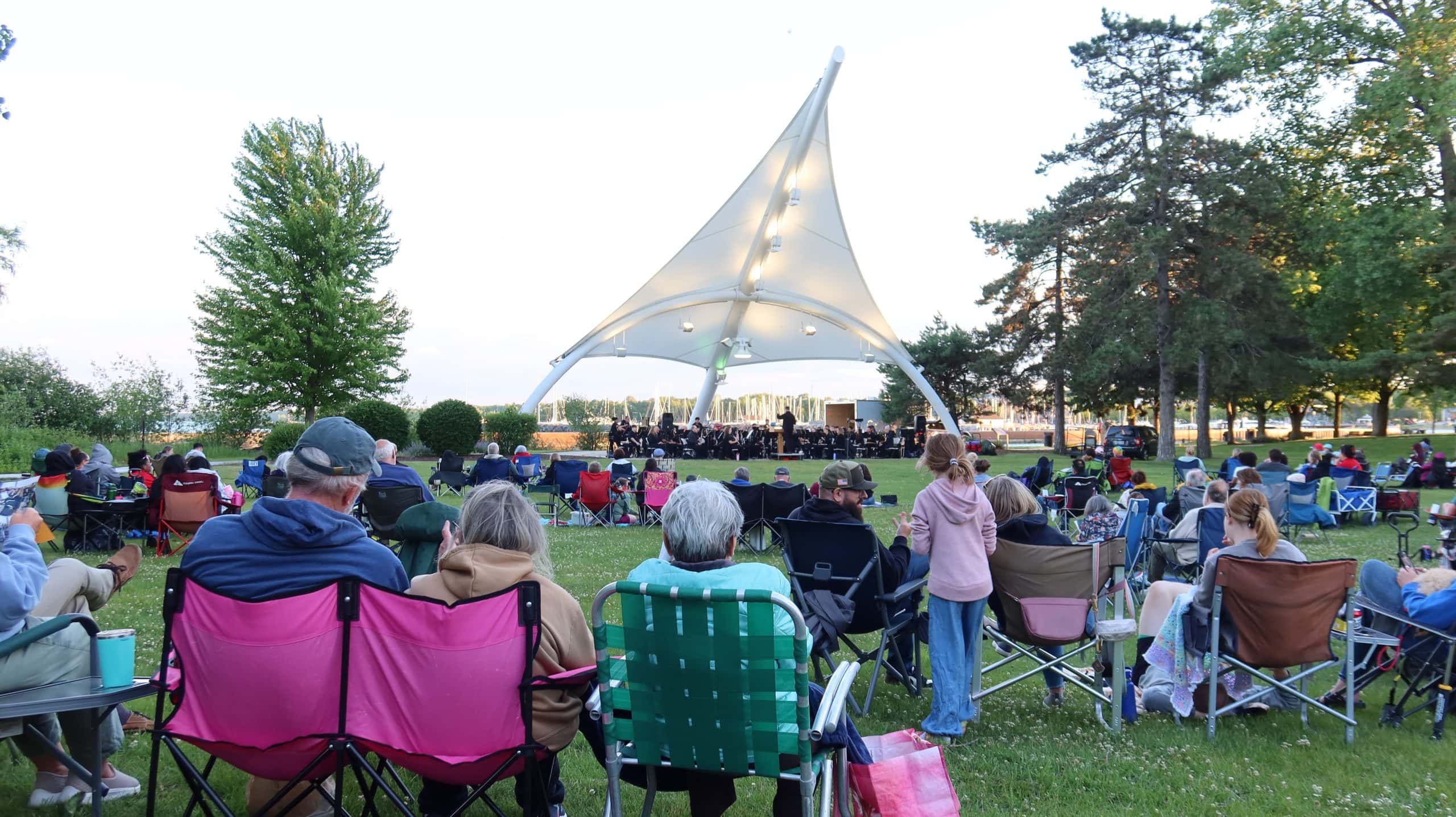 People enjoying a concert at a park in Waukegan, IL near Lake Michigan.