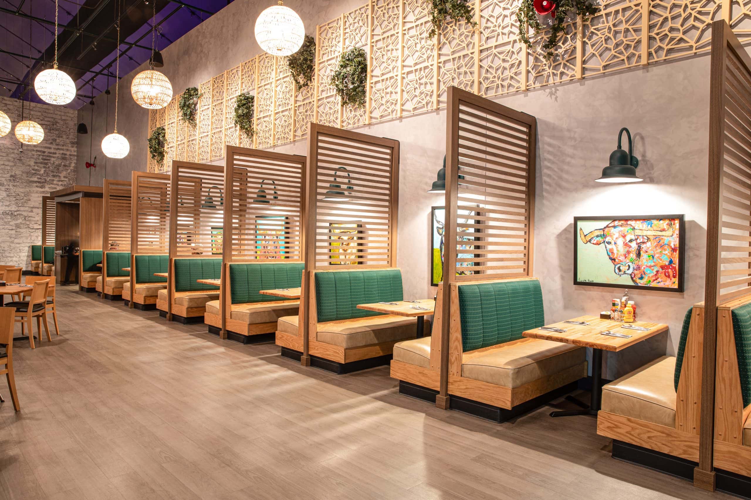 Modern restaurant booths with green seating and wooden dividers in Waukegan, IL.