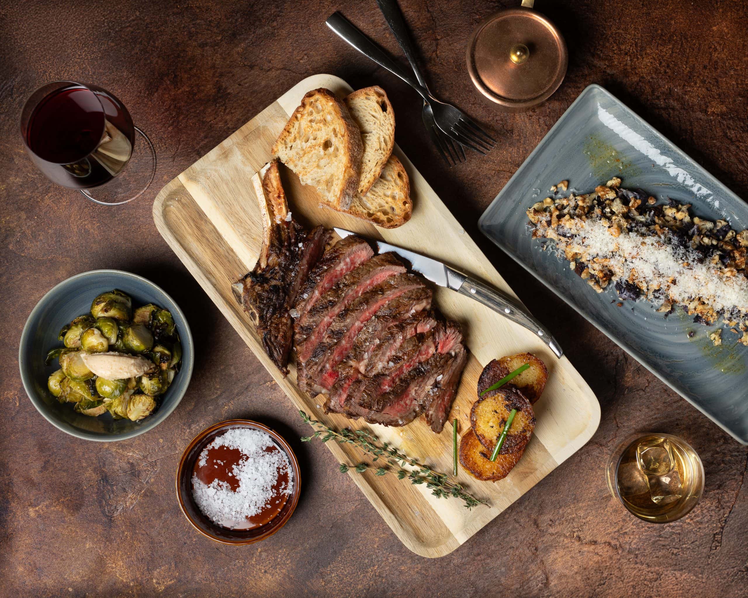 Juicy grilled steak with bread, roasted potatoes, and wine in Waukegan, IL.